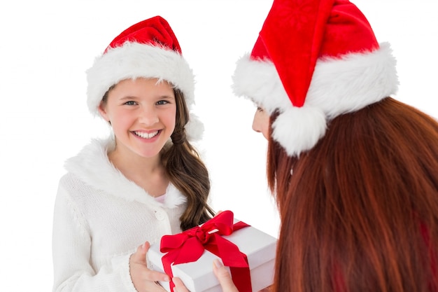 Festive mother giving daughter a gift