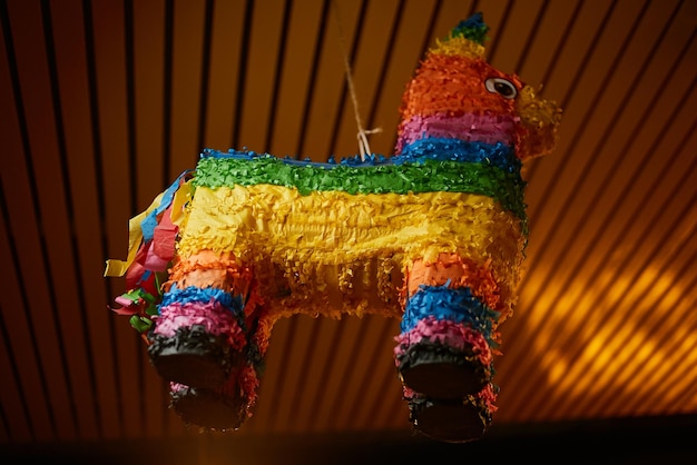 Photo festive multi-colored pinata in the form of a llama. mexican hollow toy