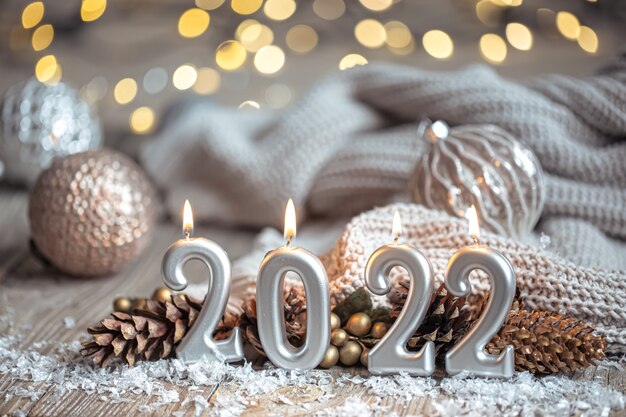 Festive New Year background with candles in the form of the numbers 2022.