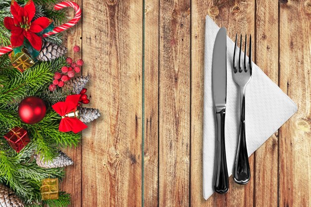 Festive New Year Christmas dinner concept. Christmas decorations and Cutlery on a table.