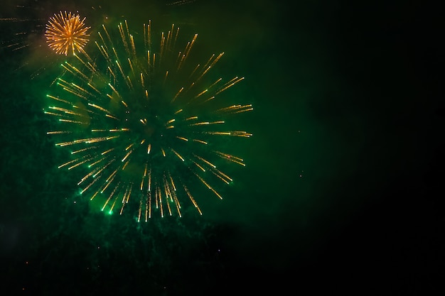 Festive New Year's fireworks in the dark sky. The bright lights are sparkling