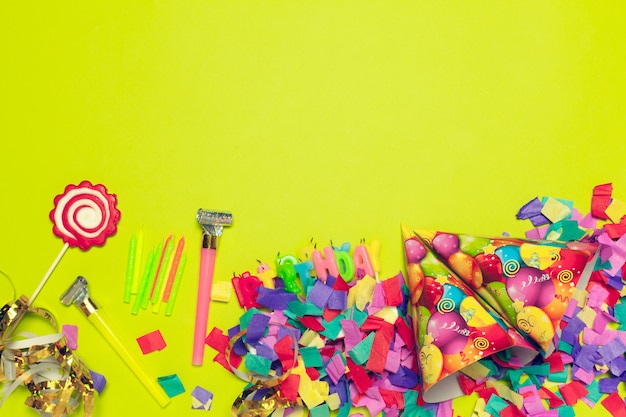 Festive party decor and confetti on colored background