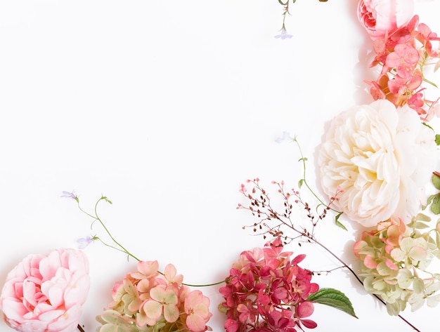 Festive pink flower English rose, hydrangea composition on the white background. Overhead top view, flat lay. Copy space. Birthday, Mother's, Valentines, Women's, Wedding Day concept.