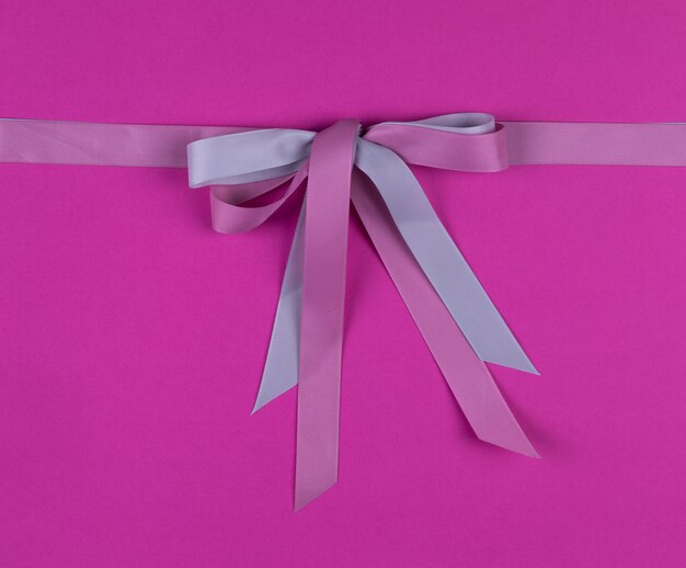 festive red bow isolated on pink background