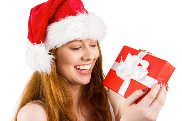 Festive redhead holding a gift