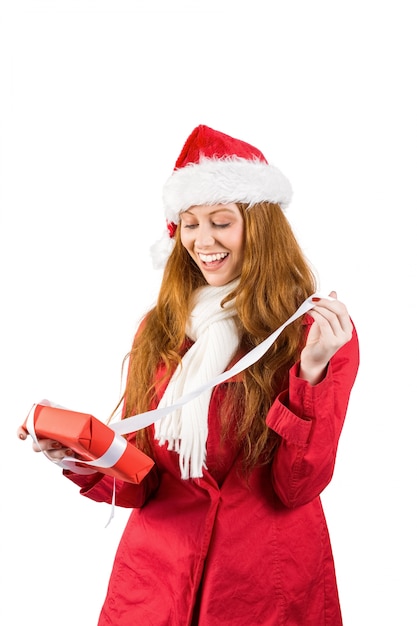 Festive redhead holding pile of gifts