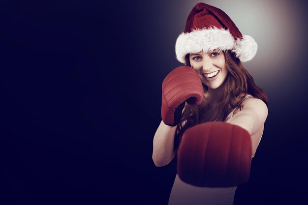 Festive redhead punching with boxing gloves