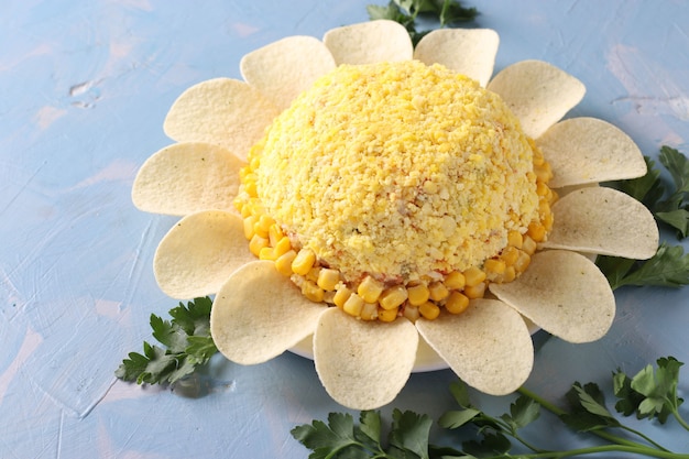 Photo festive salad chamomile with eggs, corn and chips