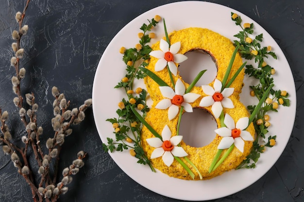 Festive salad in the form of the figures eight on a dark background International Women's Day