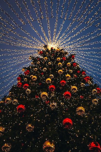 Festive sparkling garlands and gold decorations with Christmas tree as symbol of Happy New Year