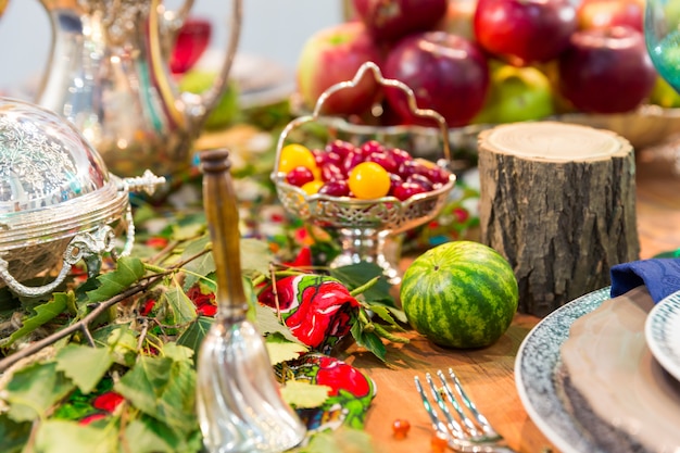 Festive table decorated with fruits closeup, nobody. Holiday celebration