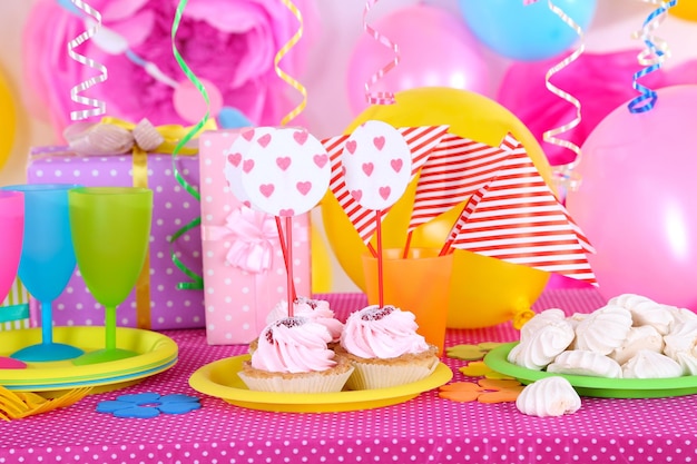 Festive table setting for birthday on celebratory decorations