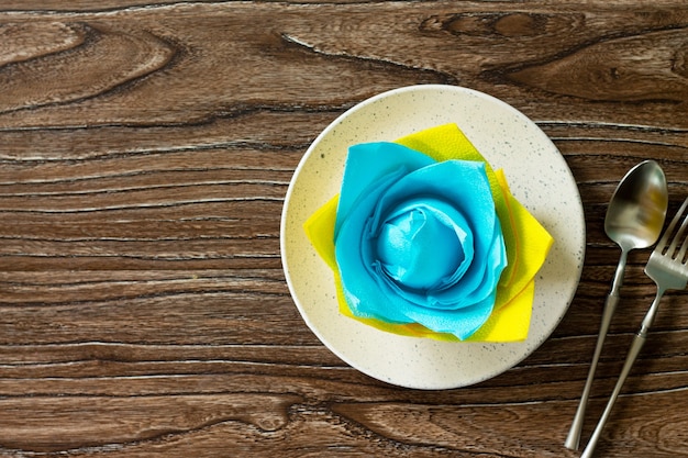 Festive table setting Culinary background with napkin and empty stove on a table Top view