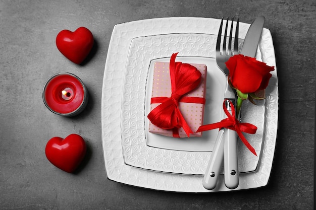 Festive table setting for Valentines Day on gray background