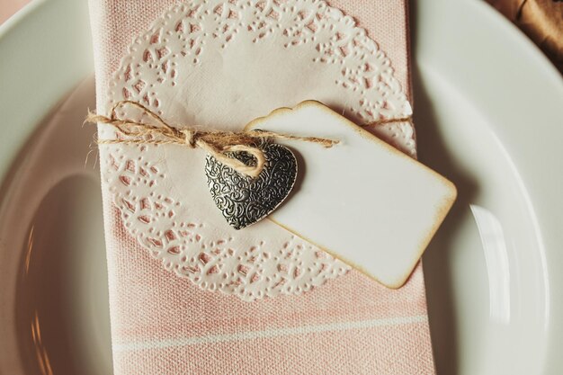 Festive table setting for Valentines Day withtable napkin sign for the inscription and hearts