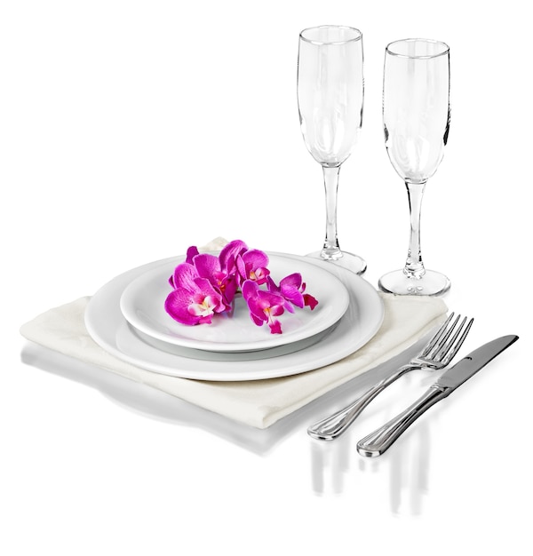 Festive table setting with flowers isolated on white