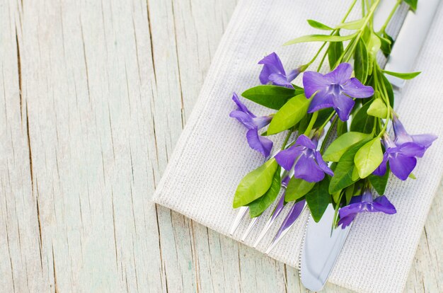 Festive Table setting with purple flowers.