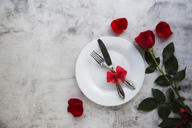 Festive table setting with red roses for valentines day.