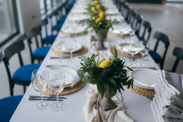 Festive table at the wedding party decorated with lemon arrangements