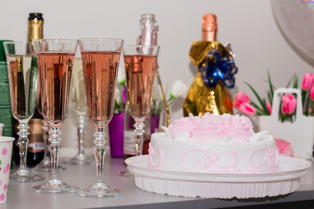 Festive table with champagne and cake