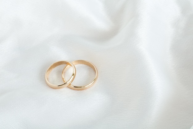 Festive wedding background with two gold rings