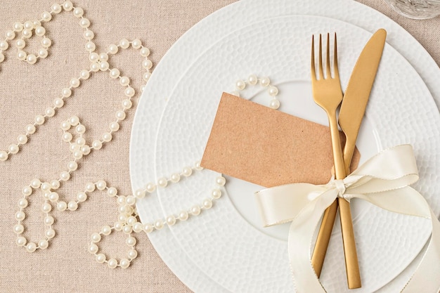 Festive wedding birthday table setting with golden cutlery