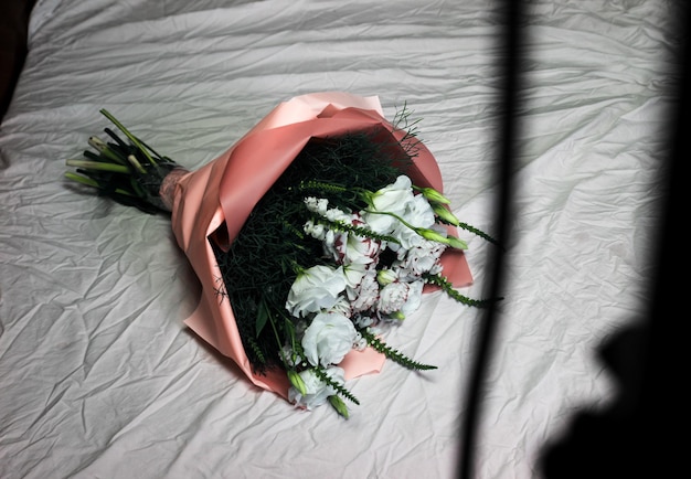 Festive white bouquet of flowers on a white background against the background