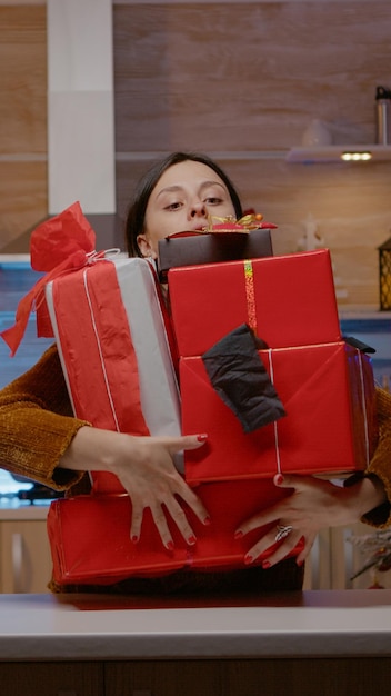 Festive woman feeling frustrated about christmas festivity, dropping gift boxes on floor, preparing presents for holiday celebration. Couple with gifts for relatives sharing christmas spirit.