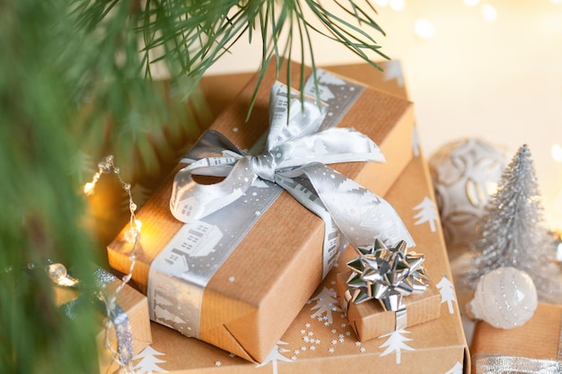 Festive zero waste gift boxes under Christmas tree in the home interior of the living room New year holiday cozy mood festive concept