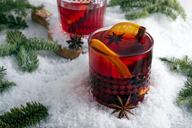 Festively stylized cocktail on the snow and scattered spruce branches
