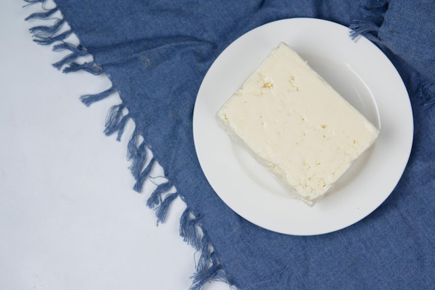 Feta cheese cube on on a plate on table