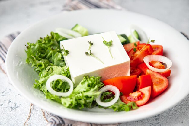 Feta salad cucumber tomato lettuce vegetables healthy meal diet snack on the table