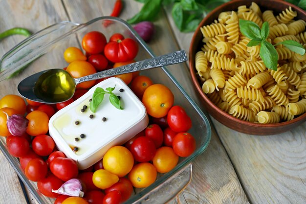 Feta tomatoes and basil in a baking dish Cooking feta tomato paste