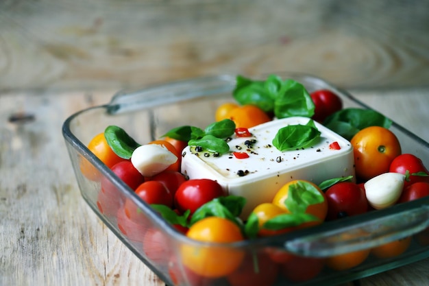 Feta tomatoes and basil in a baking dish Cooking feta tomato paste