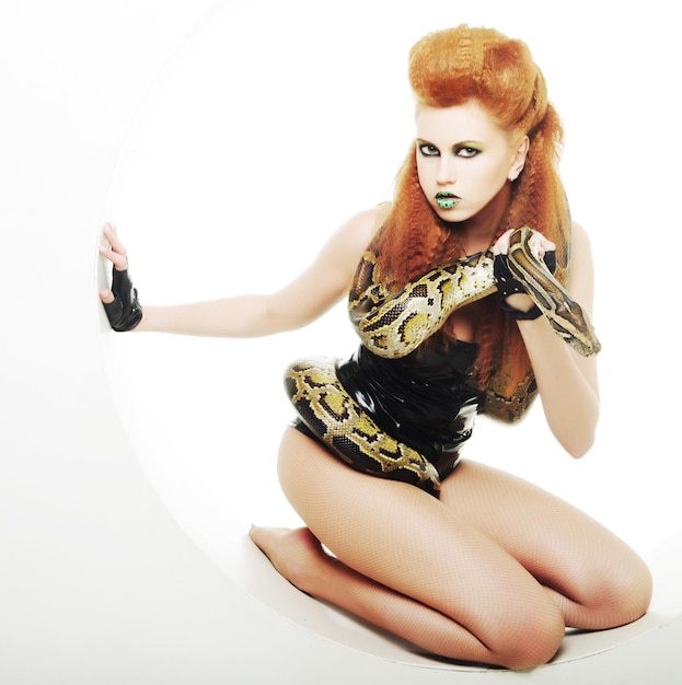 Fetish woman with creative make up holding Python