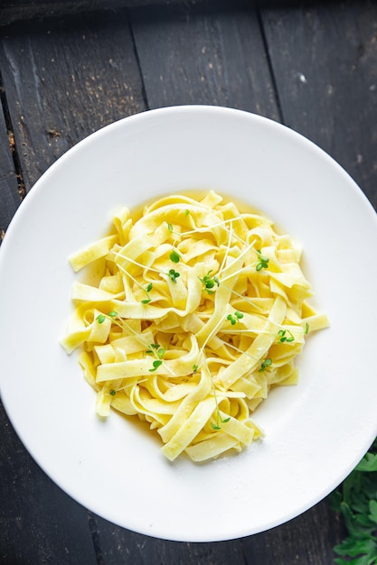 Fettuccine pasta or Tagliatelle creamy parmesan sauce healthy meal food diet snack on the table