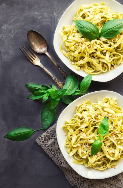 fettuccine pasta with pesto sauce basil and pine nuts on concrete background italian cuisine