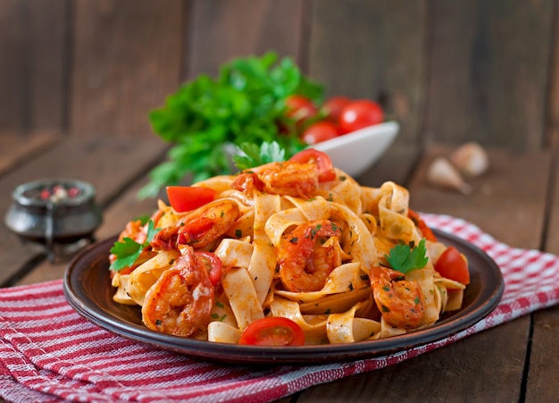 Fettuccine pasta with shrimp, tomatoes and herbs