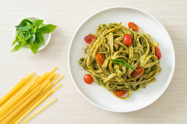 fettuccine spaghetti pasta with pesto sauce and tomatoes - vegan and vegetarian food style