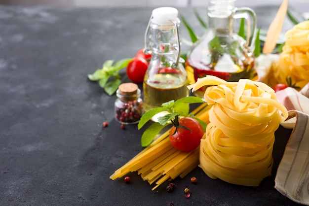 Fettuccine and spaghetti with ingredients for cooking pasta 