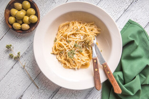 Фото Феттучини альфредо в тарелке с оливками