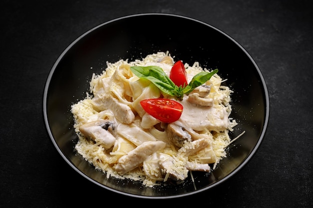 Fetuchini alfredo with mushrooms and chicken in creamy cheese sauce