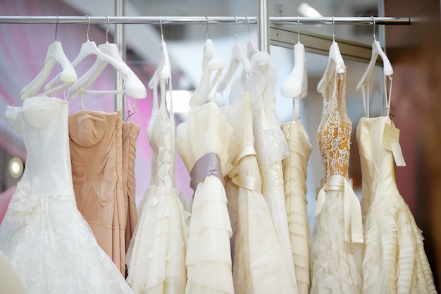 A few beautiful wedding dresses on a hanger 