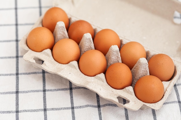 A few brown eggs among the empty cells of a large cardboard bag