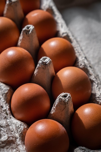 A few brown eggs among the empty cells of a large cardboard bag