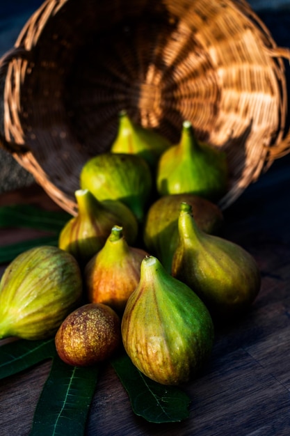 A few figs on an brown wooden background in sunshine