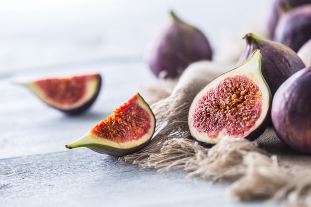 A few figs freely lying on old wooden table.