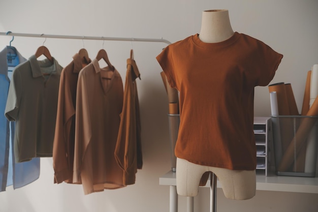 A few finishing touches and itll be ready Shot of a young fashion designer working on a garment hanging over a mannequin