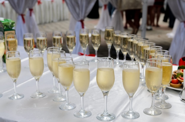 A few glasses of champagne arranged on a table in the shape of a heart