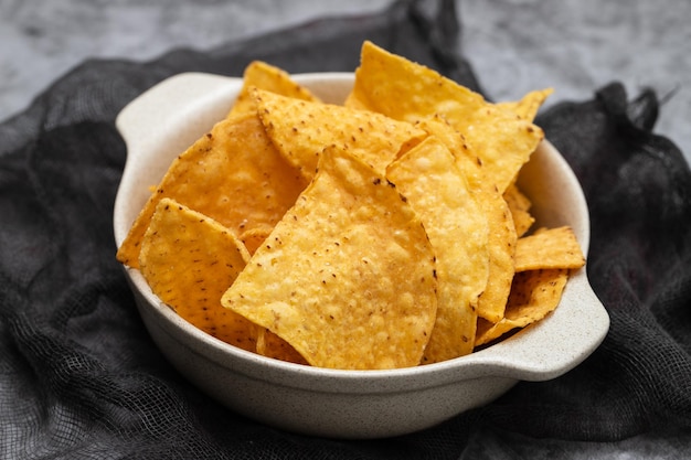 Few mexican nachos chips in small bowl